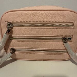 Stylish Pink Crossbody Bag with Textured Leather and Multiple Zippers